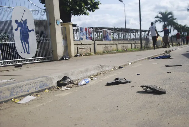A view of flip fops and sandals on the street, following a stampede in Port Harcourt, Nigeria, Saturday, May 28, 2022. Police say a stampede at a church charity event in southern Nigeria has left at least 31 people dead and seven injured. One witness said the dead included a pregnant woman and “many children”. Police said the stampede took place at an annual “Shop for Free” program organized by the Kings Assembly Pentecostal church in Rivers state. Such events are common in Nigeria, (Photo by AP Photo/Stringer)