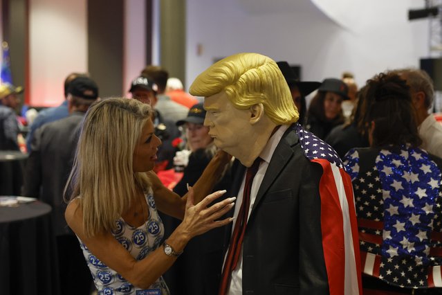 A person wearing a mask of US Republican presidential candidate Donald J. Trump (R) talks with another attendee at the Nevada Republican Party watch party at the Ahern Hotel in Las Vegas, Nevada, USA, 05 November 2024. Voters across the country are casting ballots today for President of the United States in a tightly contested race between Republican presidential candidate Donald J. Trump and Democratic presidential candidate US Vice President Kamala Harris, as well as for candidates in congressional and local races. (Photo by Caroline Brehman/EPA/EFE)