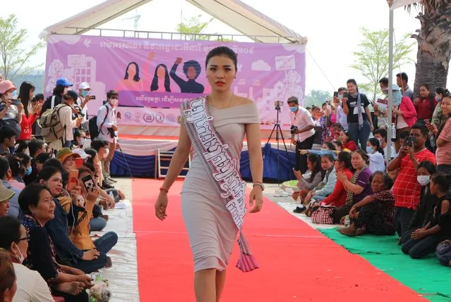 A women performs fashion show with slogans to promote respect for women's rights as groups of citizens, workers, and civil society representatives celebrate the 109th International Women Rights Day at Freedom Park in Phnom Penh on March 8, 2020. (Photo by Kann Vicheika/VOA Khmer)