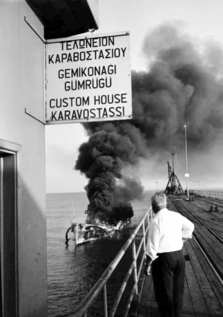 A Greek Cypriot patrol boat burns fiercely, after an attack by Turkish Air Force jets, off Xeros, Cyprus, on July 8, 1964. Six of its crew were reported to have been killed and 15 others wounded. (Photo by AP Photo)