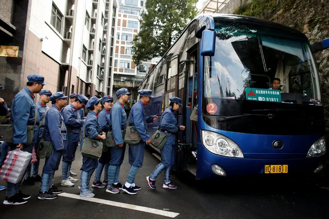 Participants dressed in replica red army uniforms board a bus to take part in a Communist team-building course extolling the spirit of the Long March, organised by the Revolutionary Tradition College, in the mountains outside Jinggangshan, Jiangxi province, China, September 14, 2017. (Photo by Thomas Peter/Reuters)