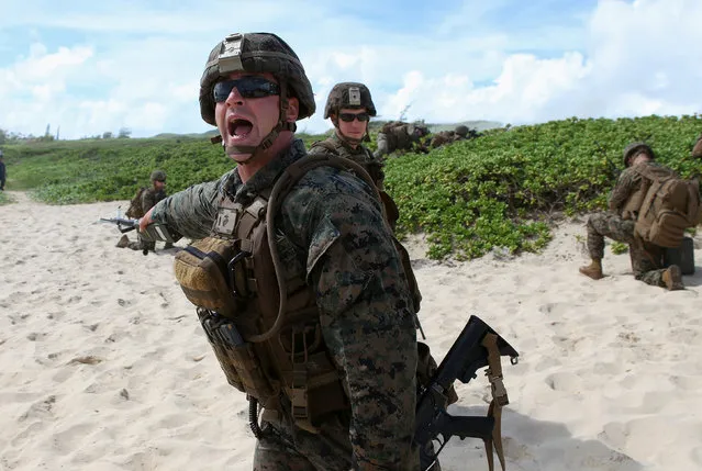 U.S. Marine Lieutenant Ben Nelson gives orders during a simulated beach assault at Marine Corps Base Hawaii with the 3rd Marine Expeditionary Unit during the multi-national military exercise RIMPAC in Kaneohe, Hawaii, July 30, 2016. (Photo by Hugh Gentry/Reuters)