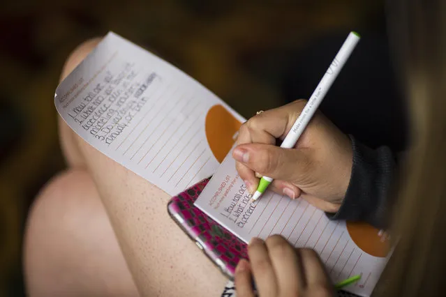 A camp attendee writes down questions to ask Victoria Henley, formerly of Americas Next Top Model, at a modeling camp at the Courtyard Marriott Hotel in McLean, Va., on Tuesday, August 18th, 2015. (Photo by Brittany Greeson/The Washington Post)