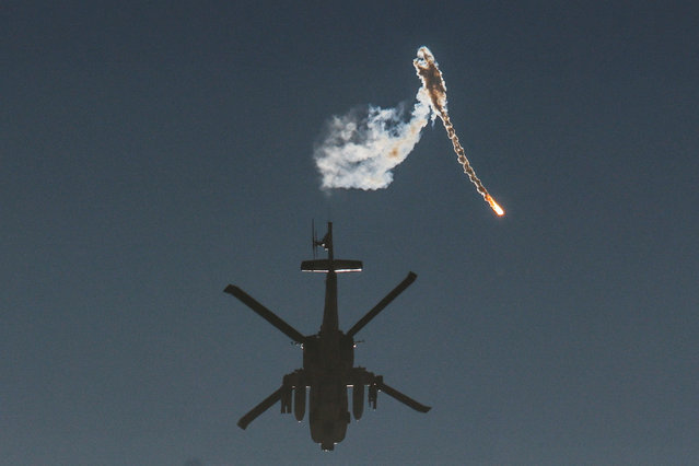 An Israeli military helicopter releases a flare over the Israel-Gaza border, after a temporary truce between Israel and the Palestinian Islamist group Hamas expired, as seen from southern Israel, December 1, 2023. (Photo by Amir Cohen/Reuters)