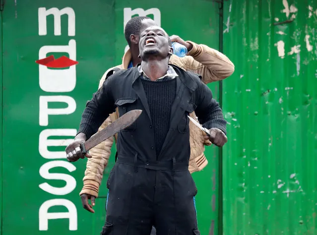 An opposition supporter gestures during clashes with police in Kibera slum in Nairobi, Kenya on October 26, 2017. (Photo by Goran Tomasevic/Reuters)