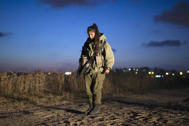 An Israeli soldier stands still at an Iron Dome unit in the coastal city of Ashkelon, north of the Gaza Strip, as a one-minute siren marking Memorial Day is sounded across Israel May 8, 2011. (Photo by Amir Cohen/Reuters)