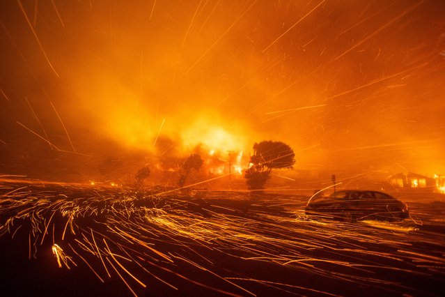 The wind whips embers as the Palisades Fire burns during a windstorm on the west side of Los Angeles on January 7, 2025. (Photo by Ringo Chiu/Reuters)