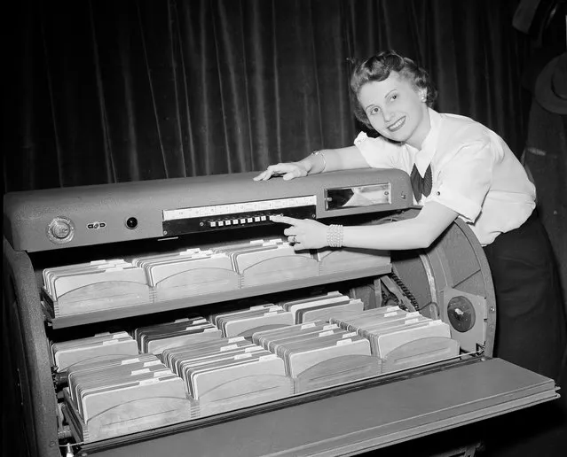 Barbara Johnson of Chicago pushes one of ten buttons that puts one of the card cradles in place in one of the new motorized card-finding systems shown during the 13th Annual Chicago Business Show, March 3, 1952. The unit contains about 82,000 tabulation cards. Called “Simplafind”, it is a product of the Simpla Research and Manufacturing Co., Inc., of New York. The company was one of 77 manufacturers of business machine equipment to display their products at the Conrad Hilton Hotel in Chicago. (Photo by Edward Kitch/AP Photo)