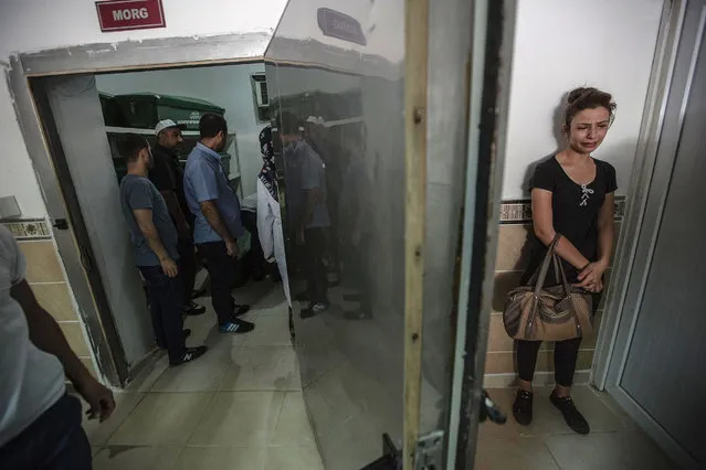 A woman cries at the morgue as she waits for the coffin of her relative, killed during last night's attack on a wedding party that left 50 dead in Gaziantep in southeastern Turkey near the Syrian border on August 21, 2016. At least 50 people were killed when a suspected suicide bomber linked to Islamic State jihadists attacked a wedding thronged with guests, officials said on August 21. (Photo by Ahmed Deep/AFP Photo)