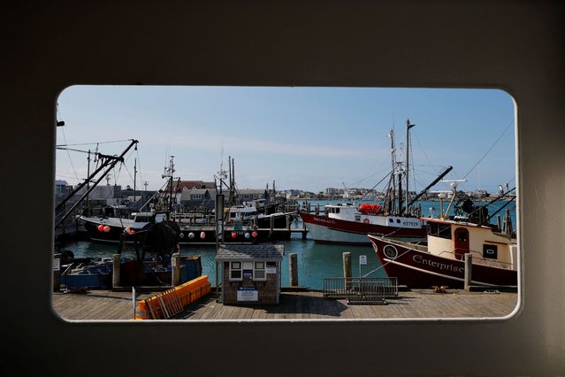 Commercial fishing boats are framed from a window of the ferry to Block Island, as cuts by U.S. President Donald Trump's administration to NOAA (National Oceanographic and Atmospheric Administration) imperil key fishing data and research, in Point Judith, Rhode Island, U.S., March 13, 2025. (Photo by Brian Snyder/Reuters)