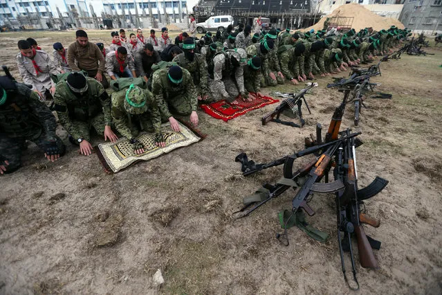 Palestinian Hamas militants pray before the start of a military show ahead of the 30th anniversary of Hamas' founding, in Khan Younis in the southern Gaza Strip, December 5, 2017. (Photo by Ibraheem Abu Mustafa/Reuters)