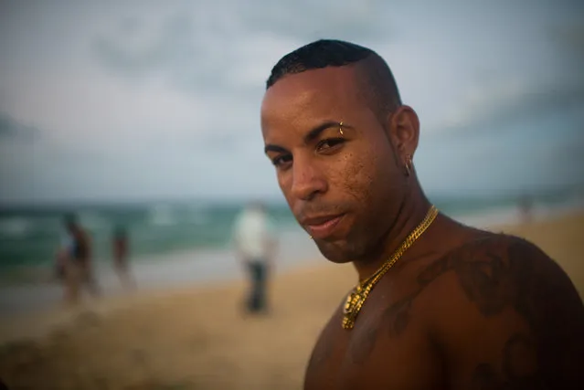 Yosbani Estanque, 24, is pictured at Santa Maria beach, about 15 miles from Havana. It is the closest beach to Havana. Estanque is part of a rap group who were gathered at the beach practicing their songs. The government is demolishing buildings all over the coast of East Havana and recovering and restoring beach dunes. (Photo by Sarah L. Voisin/The Washington Post)