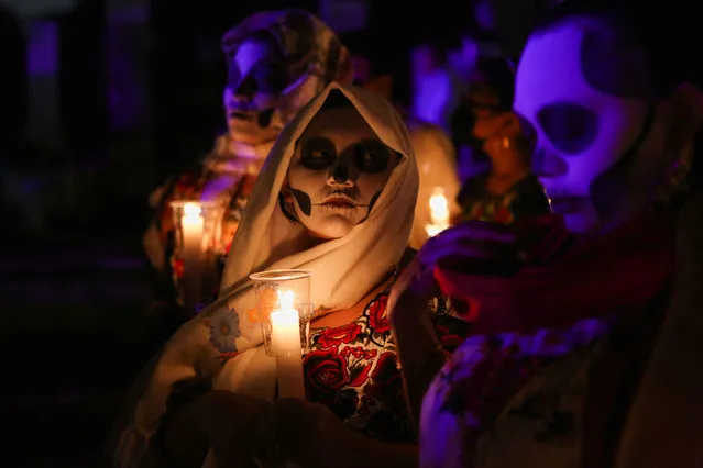 People with their faces painted as skulls participate in the traditional Mayan commemoration of the dead “Hanal Pixan” or “Parade of the Souls” (Paseo de las Animas) during Day of the Dead celebrations, in Merida, Mexico on October 28, 2022. (Photo by Lorenzo Hernandez/Reuters)