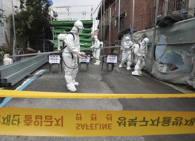 Public officials disinfect a church as a precaution against the coronavirus in Seoul, South Korea, Friday, August 14, 2020. South Korea reported over 100 new virus cases Friday, one of its biggest daily jumps in months, as officials express concerned that infections are getting out of control in cities as people increasingly venture out in public. (Photo by Han Jong-chan/Yonhap via AP Photo)