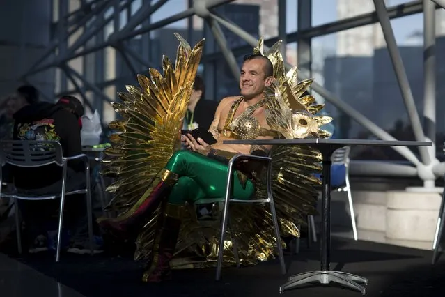 Diego Vargas sits at a table at New York Comic Con in Manhattan, New York, October 8, 2015. The event draws thousands of costumed fans, panels of pop culture luminaries and features a sprawling floor of vendors in a space equivalent to more than three football fields at the Jacob Javits Convention Center on Manhattan's West side. (Photo by Andrew Kelly/Reuters)