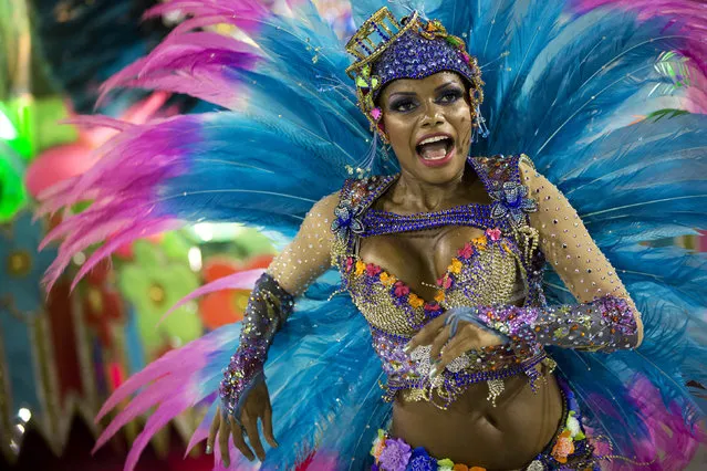 A performer from the Unidos de Vila Isabel samba school parades during Carnival celebrations at the Sambadrome in Rio de Janeiro, Tuesday, February 12, 2013. Rio de Janeiro's samba schools vied for the title of the year's best in an over-the-top, all-night-long Carnival parade at the city's iconic Sambadrome. (Photo by Felipe Dana/AP Photo)