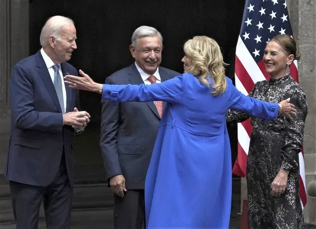 U.S. First Lady Jill Biden opens her arms to embrace Mexico's President Andres Manuel Lopez Obrador, his wife Beatriz Gutiérrez Müller, and U.S. President Joe Biden at the National Palace in Mexico City, Monday, January 9, 2023. (Photo by Fernando Llano/AP Photo)