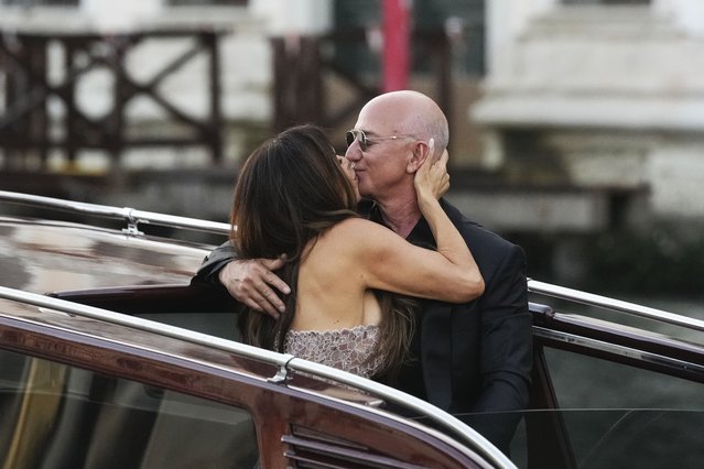 Lauren Sanchez Bezos, left, kisses Jeff Bezos as they depart from the Aman hotel during wedding celebrations in Venice, Italy, Saturday, June 28, 2025. (Photo by Luca Bruno/AP Photo)