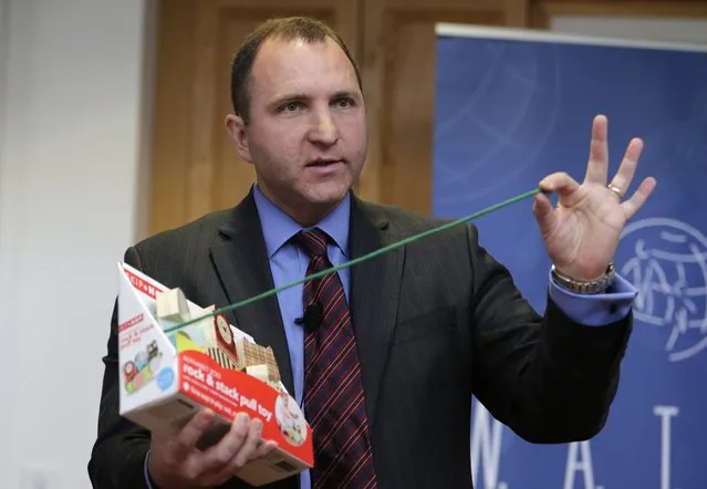 James Swartz, director of World Against Toys Causing Harm Inc., holds up a string on a children's pull toy at Children's Franciscan Hospital in Boston, Wednesday, November 19, 2014. (Photo by Charles Krupa/AP Photo)