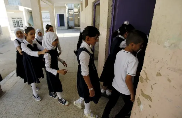 Students attend the first day of the new school term in Baghdad, October 18, 2015. (Photo by Ahmed Saad/Reuters)