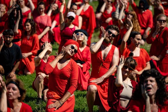 Dancers dressed in red perform during the “Most Wuthering Heights Day Ever” get together in Goerlitzer Park in Berlin on July 19, 2025. Originating in Berlin and organised by Australian Berlin resident Samantha Wearing, The Most Wuthering Heights Day Ever is an annual event held at many locations around the world where participants recreate the music video for musician Kate Bush's 1978 song “Wuthering Heights”. (Photo by Odd Andersen/AFP Photo)