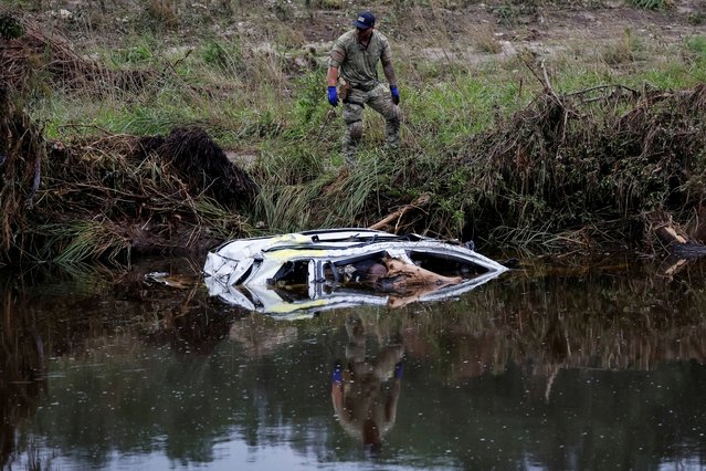 A law enforcement member works in recovery operations following flooding on the Guadalupe River, in Camp Mystic, Hunt, Texas, U.S. July 7, 2025. (Photo by Marco Bello/Reuters)