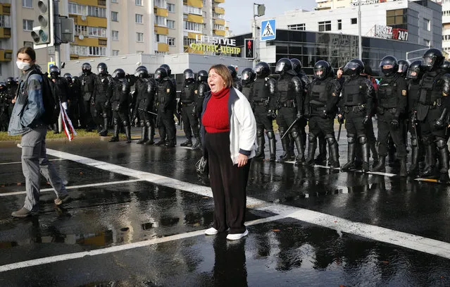 A protester shouts in front of a riot police line during a rally in Minsk, Belarus, Sunday, October 4, 2020. Hundreds of thousands of Belarusians have been protesting daily since the Aug. 9 presidential election. (Photo by AP Photo/Stringer)