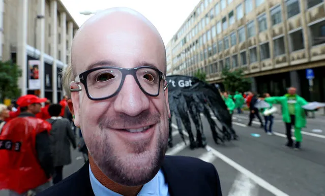A man wears a mask depicting Belgian Prime Minister Charles Michel during a protest over the government's reforms and cost-cutting measures, in Brussels, Belgium September 29, 2016. (Photo by Yves Herman/Reuters)