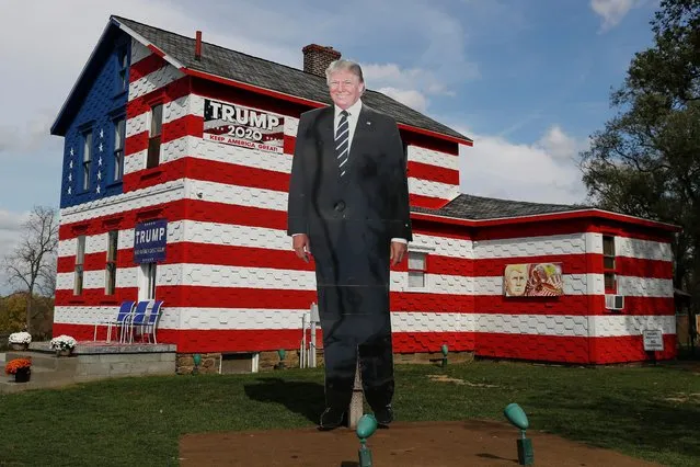 A 14-foot cutout of President Donald Trump stands on the front lawn of the self-proclaimed “Trump House” in Youngstown in the battleground state of Pennsylvania, October 21, 2020. (Photo by Shannon Stapleton/Reuters)