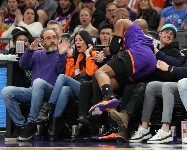 Phoenix Suns guard Chris Paul (3) crashes into fans during the second half of the game against the LA Clippers at Footprint Center in Phoenix, Arizona on February 16, 2023. (Photo by Joe Camporeale/USA TODAY Sports)