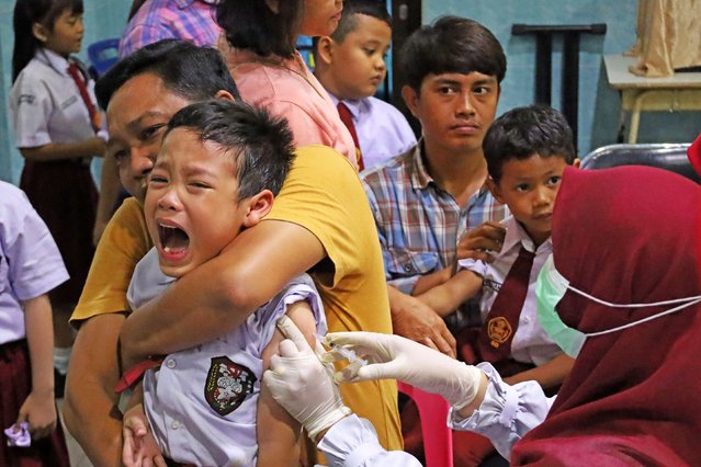 A student cries as officers inject a vaccine during the implementation of the school child Immunization Month (BIAS) in the city of Banda Aceh, Indonesia, on Wednesday, August 20, 2025. (Photo by ZUMA Press/Alamy Live News)