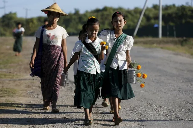 Girls walk to school at the outskirts of Yangon November 4, 2015. (Photo by Jorge Silva/Reuters)