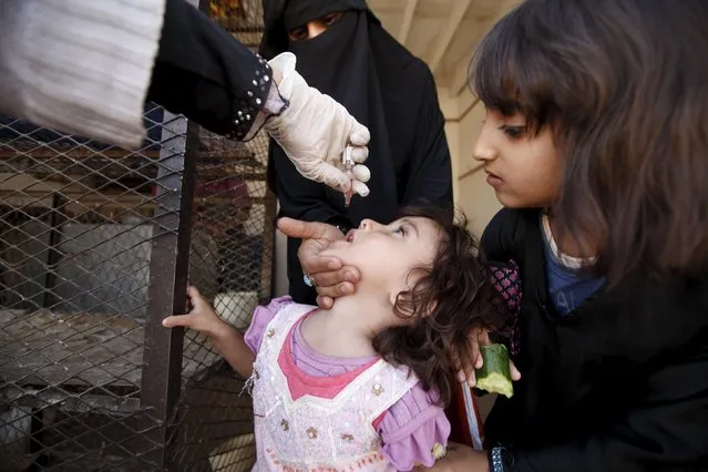 A girl receives polio vaccine drops during a house-to-house vaccination campaign in Yemen's capital Sanaa November 10, 2015. (Photo by Khaled Abdullah/Reuters)