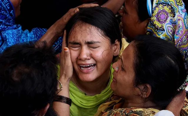 A woman mourns for her family member, who was killed in a bombing Saturday, during his funeral in Karachi, on May 5, 2013. Two blasts in Pakistan's southern city of Karachi killed three people on Saturday, near the office of a political party critical of the Taliban, heightening tensions ahead of the country's historic May 11 election. (Photo by Fareed Khan/Associated Press)