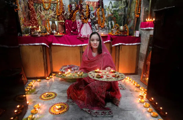 A Pakistani Hindu woman lights candles during Diwali celebrations at a local temple in Lahore, Pakistan, Wednesday, November 11, 2015. Diwali, the festival of lights, is one of Hinduism's most important festivals dedicated to the worship of Lakshmi, the Hindu goddess of wealth. (Photo by K. M. Chaudary/AP Photo)