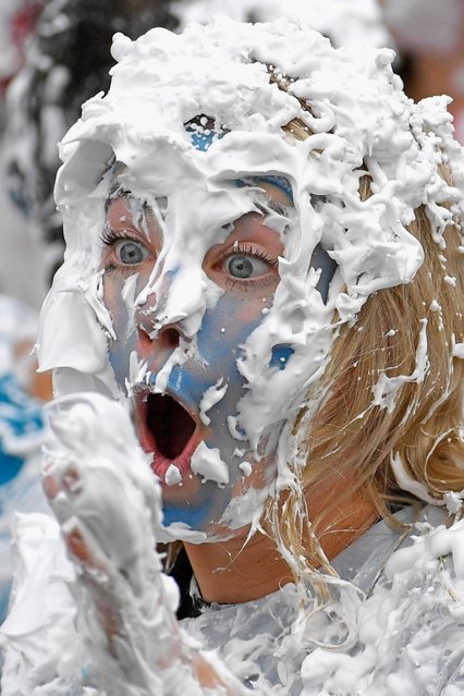 Students from St Andrew's University indulge in a tradition of covering themselves with foam to honor the “academic family” on October 17, 2015, in St Andrews, Scotland. (Photo by Jeff J. Mitchell/Getty Images)