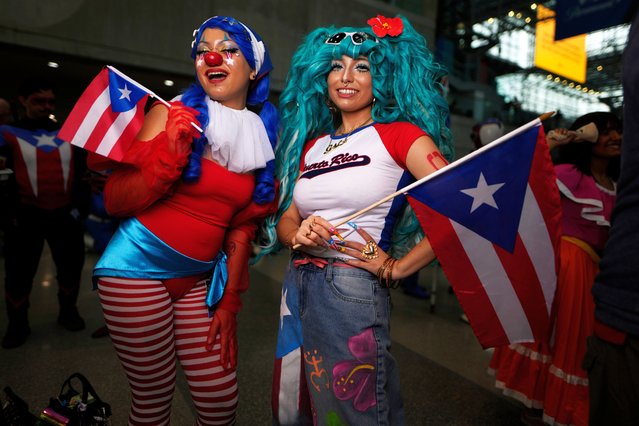 Attendees dressed as Puerto Rican-inspired Buggy the Clown, right, and Hatsune Miku pose during New York Comic Con at the Jacob K. Javits Convention Center on Saturday, October 11, 2025, in New York. (Photo by Charles Sykes/Invision/AP Photo)
