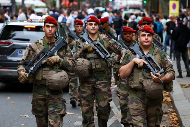 Soldiers patrol near the security perimeter for the opening ceremony which is deployed ahead of the Paris 2024 Olympics in Paris, France, on July 26, 2024. (Photo by Fabrizio Bensch/Reuters)