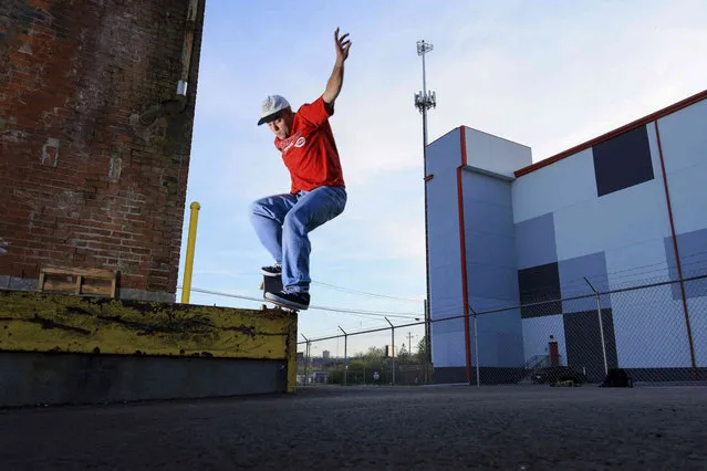 Jake Knapke skates on a delivery dock ledge, Monday, April 10, 2023, in Cincinnati. (Photo by Aaron Doster/AP Photo)