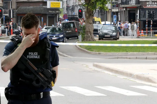 A police officer is seen on the scene of a shooting in Liege, Belgium on May 29, 2018, after a gunman shot dead three people, two of them policemen, before being killed by elite officers. The shooting occurred around 10:30 am (0830 GMT) on a major artery in the city close to a high school. “We don' t know anything yet”, the spokeswoman for the Liege prosecutors office, told AFP when asked about the shooter' s motives. (Photo by Francois Lenoir/Reuters)