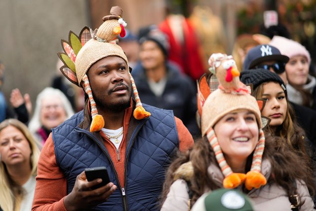 Spectators watch as balloons and floats pass on Sixth Avenue during the Macy's Thanksgiving Day Parade, Thursday, November 27, 2025, in New York. (Photo by Eduardo Munoz Alvarez/AP Photo)