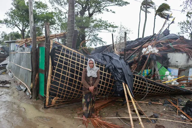 A woman stands next to her damaged house after cyclone Mocha's landfall at the Shahpori Dwip, Teknuf area near Cox's Bazar, Bangladesh, 14 May 2023. Powerful cyclone Mocha made landfall mainly in Myanmar tearing the roofs and also made effect at the Bangladesh-Myanmar border line. (Photo by EPA/EFE/Rex Features/Shutterstock)