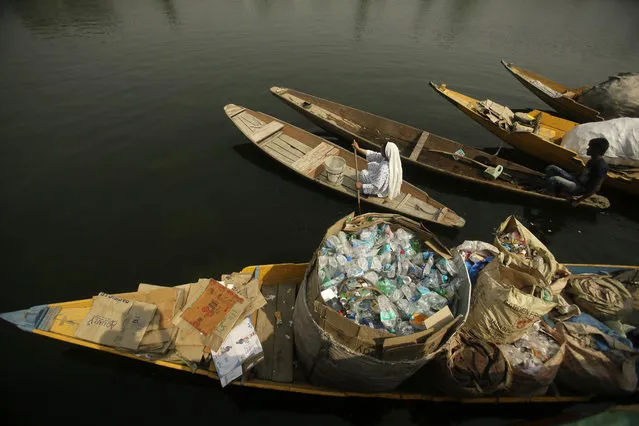 A Kashmiri woman rows her boat past another loaded with plastic bottles and other waste collected from the Dal Lake as a cleanliness initiative on World Environment Day in Srinagar, Indian controlled Kashmir, Tuesday, June 5, 2018. “Plastic pollution is a huge issue everywhere”, U.N. Environment chief Erik Solheim told The Associated Press in an interview. He praised India for its growing focus on environmental protection but also noted that while traveling in the country he'd seen “some of the most beautiful scenic places, but destroyed by plastic pollution”. (Photo by A.M. Ahad/AP Photo)