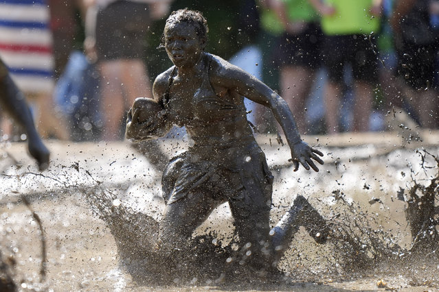 Mahala Smith, of Sabattus, Maine, scrambles for yardage during a women's football game at the Mud Bowl in North Conway, N.H., Saturday, September 7, 2024. (Photo by Robert F. Bukaty/AP Photo)