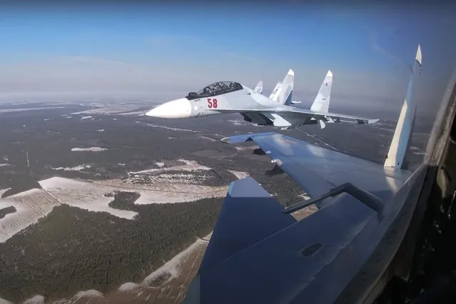 In this photo taken from video provided by the Russian Defense Ministry Press Service on Thursday, February 17, 2022, Su-30 fighters of the Russian and Belarusian air forces fly in a joint mission during the Union Courage-2022 Russia-Belarus military drills in Belarus.Russian President Vladimir Putin has announced that he intends to deploy tactical nuclear weapons on the territory of Belarus. The move appears to be another attempt by Putin to raise the stakes in the conflict in Ukraine. (Photo by Russian Defense Ministry Press Service via AP Photo)
