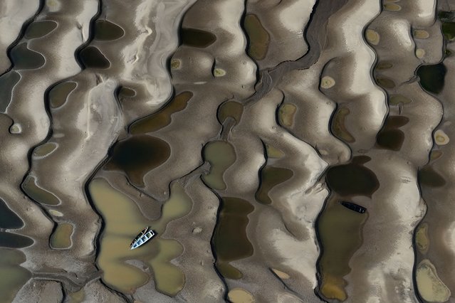 A drone view shows stranded boats over the sandbanks exposed due to drought at the Solimoes River, one of the largest tributaries of the Amazon River, during the most intense and widespread drought Brazil has experienced since records began in 1950, near Manacapuru, Amazonas state, Brazil on September 30, 2024. (Photo by Bruno Kelly/Reuters)