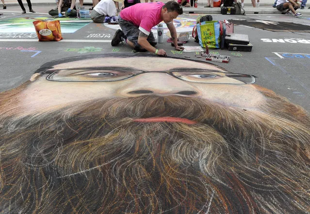 Artist Eric Matelski works on his creation titled “The Beard”. Crowds gather in Larimer Square for the Denver Chalk Art Festival with more than 200 professional, amateur, and student artists spending hours on their hands and knees creating the vivid chalk paintings on June 3, 2018 in Denver, Colorado. (Photo By Kathryn Scott/The Denver Post)