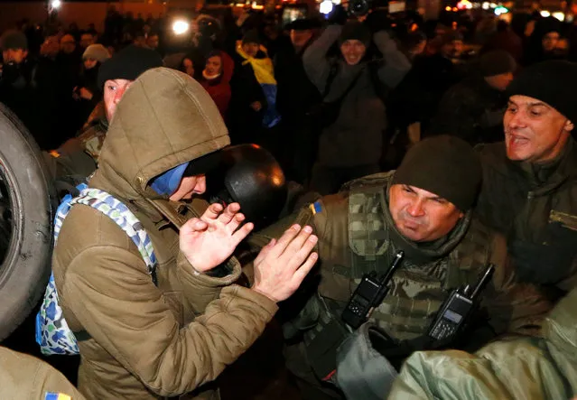 Law enforcement personnel block and clash with activists of nationalist groups and their supporters, who mark the anniversary of the 2014 Ukrainian pro-European Union (EU) mass protests on the Day of Dignity and Freedom in central Kiev, Ukraine, November 21, 2016. (Photo by Valentyn Ogirenko/Reuters)