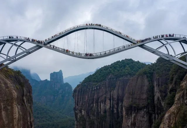 Photo taken from aerial view shows the “Ruyi Bridge” in the Shenxianju Scenic Area, which is shaped like a jade Ruyi in the sky, attracting many tourists to take pictures in Xianju county of Taizhou City, East China's Zhejiang Province, 24 March 2021. (Photo by Rex Features/Shutterstock)