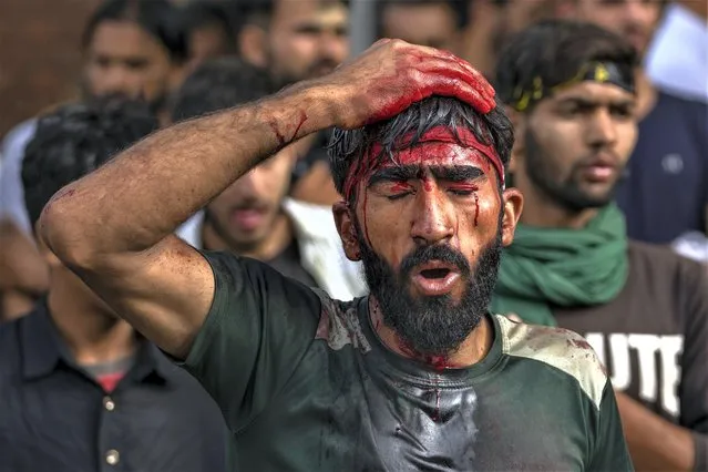 A Kashmiri Shiite Muslim mourns as he flagellates himself during a Muharram procession in Srinagar, Indian controlled Kashmir, Thursday, July 27, 2023. Muharram is a month of mourning for Shiite Muslims in remembrance of the martyrdom of Imam Hussein, the grandson of the Prophet Muhammad. (Photo by Dar Yasin/AP Photo)